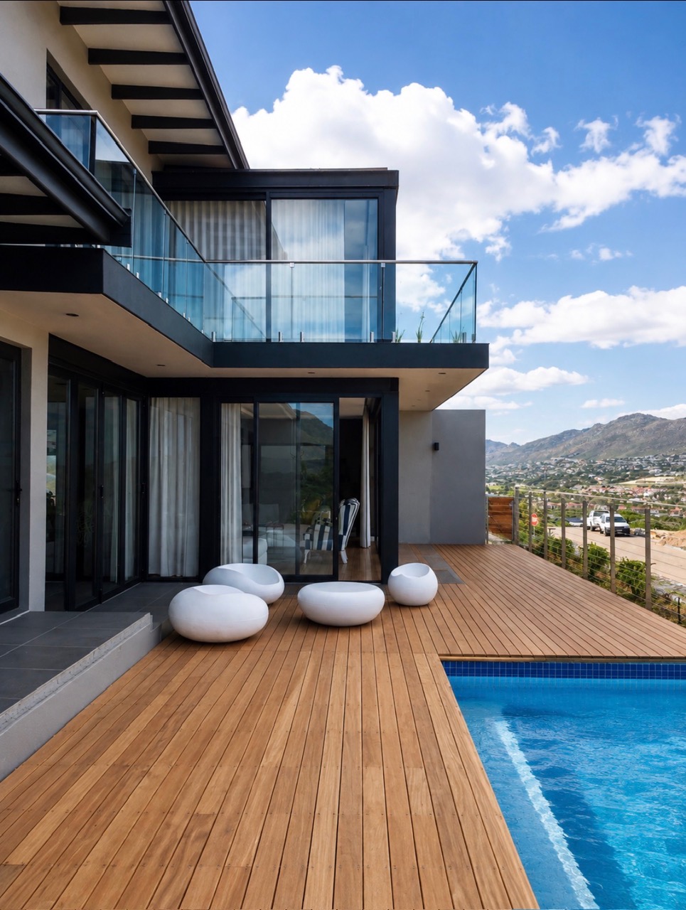 Hardwood pool deck and glass balustrades with mountain views at Chapmans Bay Estate